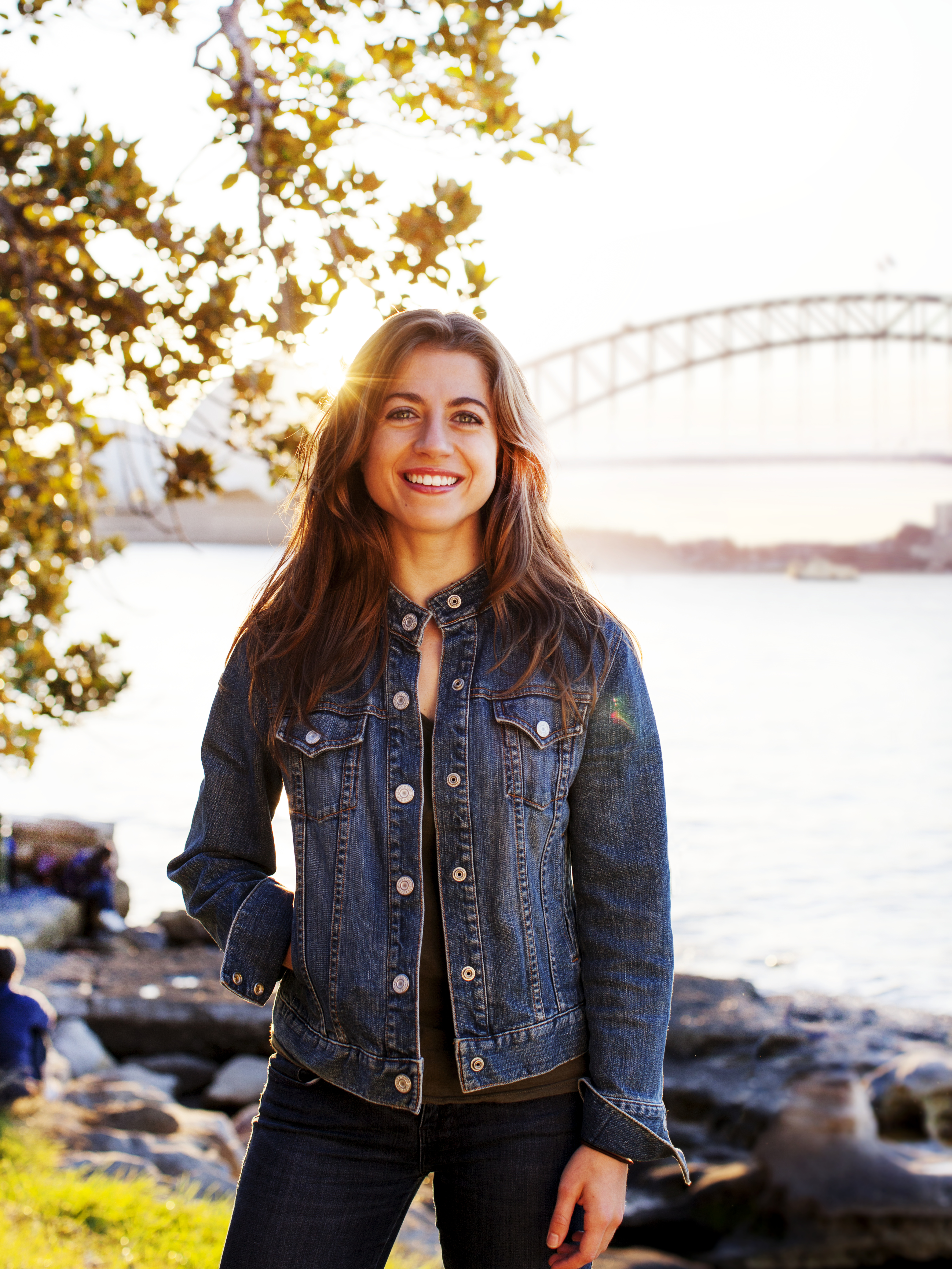 Women standing in front of the Sydney Harbour bridge and Opera house in the background